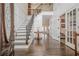 Grand foyer with hardwood floors, staircase, and elegant decor at 210 Little River Farms Trl, Canton, GA 30115