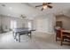 Spacious game room featuring a ping pong table, ceiling fans, and neutral color scheme at 210 Little River Farms Trl, Canton, GA 30115