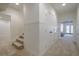 Well-lit hallway with carpeted floors, white walls, and a staircase leading to another level at 210 Little River Farms Trl, Canton, GA 30115