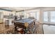 Open floor plan highlighting a modern kitchen and billiards room with outdoor access at 210 Little River Farms Trl, Canton, GA 30115