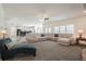 Spacious living room featuring large sectional, hardwood floors, and stone fireplace at 210 Little River Farms Trl, Canton, GA 30115