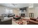 Basement living room featuring a stone fireplace, plush seating, and ample natural light at 210 Little River Farms Trl, Canton, GA 30115