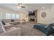Bright living room featuring a stone fireplace, recessed lighting, and plush furniture at 210 Little River Farms Trl, Canton, GA 30115