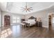 Spacious main bedroom with tray ceiling, hardwood floors, and natural light from windows at 210 Little River Farms Trl, Canton, GA 30115