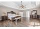 Expansive main bedroom offers plenty of natural light, hardwood floors, and tray ceiling at 210 Little River Farms Trl, Canton, GA 30115