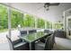 Inviting outdoor patio with elegant dining set, overlooking a lush green backyard and pool at 210 Little River Farms Trl, Canton, GA 30115