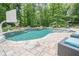 Beautifully landscaped pool area with sun loungers, a basketball hoop, and plenty of space to relax at 210 Little River Farms Trl, Canton, GA 30115