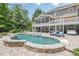 Backyard oasis with a stunning pool, sun loungers, and an expansive deck for outdoor enjoyment at 210 Little River Farms Trl, Canton, GA 30115