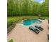 Inviting backyard pool area with chaise lounges and a basketball hoop for Gathering fun at 210 Little River Farms Trl, Canton, GA 30115