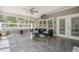 Cozy screened-in porch with comfortable seating and a ceiling fan, offering a relaxing outdoor space at 210 Little River Farms Trl, Canton, GA 30115