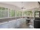 Bright and airy screened-in porch, featuring slate flooring, fan, and views of the surrounding woods at 210 Little River Farms Trl, Canton, GA 30115