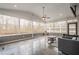 Bright sunroom with large windows, tile floor, ceiling fan, comfortable seating, and a serene outdoor view at 210 Little River Farms Trl, Canton, GA 30115