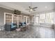 Spacious sunroom with tile floors, lots of windows, modern furniture, ceiling fan, and natural light at 210 Little River Farms Trl, Canton, GA 30115