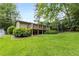 Lush backyard featuring a deck and beautiful greenery, creating a private and inviting space at 2343 Poplar Springs Ne Dr, Brookhaven, GA 30319