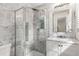 Luxurious bathroom with marble walls, glass shower, and a stylish vanity with modern fixtures at 2343 Poplar Springs Ne Dr, Brookhaven, GA 30319