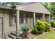 Inviting entrance to a charming home, featuring a covered porch, lush landscaping, and a warm, welcoming ambiance at 2343 Poplar Springs Ne Dr, Brookhaven, GA 30319