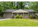 Charming home featuring a well-manicured lawn, complemented by lush greenery, offering a welcoming curb appeal at 2343 Poplar Springs Ne Dr, Brookhaven, GA 30319