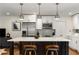 Modern kitchen features a large island, stainless steel appliances, and stylish pendant lighting at 2343 Poplar Springs Ne Dr, Brookhaven, GA 30319