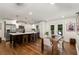 Modern kitchen featuring stainless steel appliances, a spacious island with seating, and a dining area with outdoor access at 2343 Poplar Springs Ne Dr, Brookhaven, GA 30319