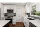 Renovated kitchen boasts stainless steel appliances, modern backsplash, and ample countertop space at 2343 Poplar Springs Ne Dr, Brookhaven, GA 30319