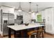 Bright kitchen with white cabinets, stainless steel appliances, and center island with seating at 2343 Poplar Springs Ne Dr, Brookhaven, GA 30319