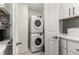 Conveniently located laundry area with stacked washer and dryer unit, next to kitchen at 2343 Poplar Springs Ne Dr, Brookhaven, GA 30319