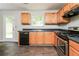 Bright kitchen featuring wooden cabinets, dark countertops, stainless-steel appliances, and exterior door at 2743 High Tide Dr, Atlanta, GA 30349