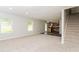 Open-concept living space with plush carpet, natural light, and a view into the kitchen area at 2743 High Tide Dr, Atlanta, GA 30349