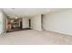 Open-concept living space with plush carpet, stairs, and a view into the kitchen area at 2743 High Tide Dr, Atlanta, GA 30349