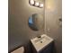 Bathroom featuring a vanity and a round mirror at 2860 Cocklebur Cove Ct, Decatur, GA 30034