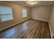 Bedroom with hardwood floors and natural light from two windows at 2860 Cocklebur Cove Ct, Decatur, GA 30034