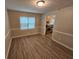 Dining room featuring hardwood floors, white trim, neutral paint, and view into the kitchen at 2860 Cocklebur Cove Ct, Decatur, GA 30034