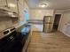 Updated kitchen with white cabinets, stainless steel appliances, granite countertops, and hardwood flooring at 2860 Cocklebur Cove Ct, Decatur, GA 30034