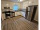 Modern kitchen featuring stainless steel appliances, granite countertops, and white cabinets at 2860 Cocklebur Cove Ct, Decatur, GA 30034