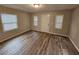Bright room with wood-look flooring, multiple windows, and ample natural light at 2860 Cocklebur Cove Ct, Decatur, GA 30034