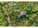 Aerial view of estate surrounded by lush, mature trees, and nearby roadways at 1260 Heards Ferry Rd, Sandy Springs, GA 30328