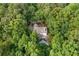 An aerial view of a secluded home surrounded by a dense forest, ensuring privacy and tranquility at 1260 Heards Ferry Rd, Sandy Springs, GA 30328