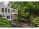 Backyard featuring a lush garden with a stone path and manicured landscaping around the perimeter of the property at 1260 Heards Ferry Rd, Sandy Springs, GA 30328