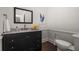 Bathroom boasts a black vanity, mirror, artwork, sink, and toilet at 1260 Heards Ferry Rd, Sandy Springs, GA 30328