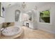 Luxurious bathroom with a jacuzzi tub, double vanity, and natural lighting at 1260 Heards Ferry Rd, Sandy Springs, GA 30328