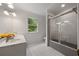 Well-lit bathroom with dual sinks, a window, and a shower-tub combination at 1260 Heards Ferry Rd, Sandy Springs, GA 30328