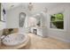 Bright bathroom with a soaking tub, dual sinks, and large windows at 1260 Heards Ferry Rd, Sandy Springs, GA 30328