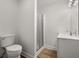 Bathroom with glass-enclosed shower, modern fixtures, toilet and vinyl flooring at 1260 Heards Ferry Rd, Sandy Springs, GA 30328