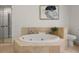 Bathroom with a large soaking tub and tiled surround with tile flooring at 1260 Heards Ferry Rd, Sandy Springs, GA 30328