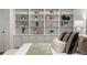 Bright bedroom with built-in shelves, decorative accents, and a large bed at 1260 Heards Ferry Rd, Sandy Springs, GA 30328