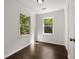 Bright bedroom with hardwood floors, two large windows, and a neutral color palette at 1260 Heards Ferry Rd, Sandy Springs, GA 30328