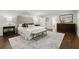 Spacious bedroom with a gray rug, and a king-sized bed with tufted headboard at 1260 Heards Ferry Rd, Sandy Springs, GA 30328