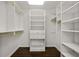 Walk-in closet with custom shelving and hardwood floor at 1260 Heards Ferry Rd, Sandy Springs, GA 30328