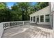 Wide outdoor deck with white railings overlooking the backyard surrounded by trees at 1260 Heards Ferry Rd, Sandy Springs, GA 30328