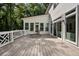 Spacious deck with lounge seating, sliding glass door access to home, and wooded scenery at 1260 Heards Ferry Rd, Sandy Springs, GA 30328